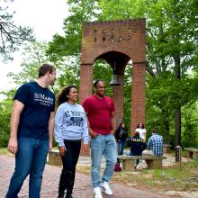 SMCM students walk by the bell tower on campus 
