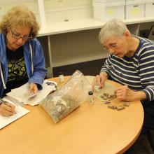 Isabel Tonkavitch and Sara Fisher cleaning and cataloging artifacts in the anthropology lab at St. Mary’s College