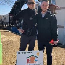 Assistant Professor Jessica Malisch and Derrick May stand by the bird feeders donated by Wild Birds Unlimited Lexington Park for Project FeederWatch at the Chesapeake Public Charter School