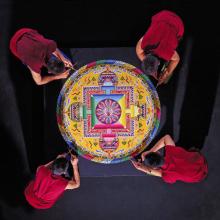 Tibetan Buddhist Monks constructing a Mandala Sand Painting shown