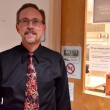 Professor Jeffrey Byrd outside of a teaching laboratory 