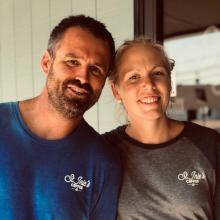 Catherine Grube '06 poses with husband Howie Grube '04 outside their Lexington Park business