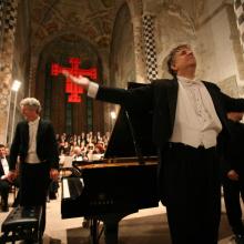 Pictured: A previous performance by Brian Ganz, left, at the Alba Music Festival in Alba, Italy, conducted by Larry Vote, center.  