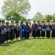 The senior members of the men’s and women’s lacrosse teams pose for grad photos after the special Grad Walk