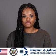 A woman with long braided hair looks at the camera. The Benjamin A. Gilman International Scholarship logo and US symbols appear at the bottom.