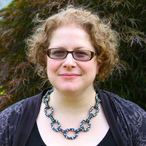 Susan Goldstine in front of foliage