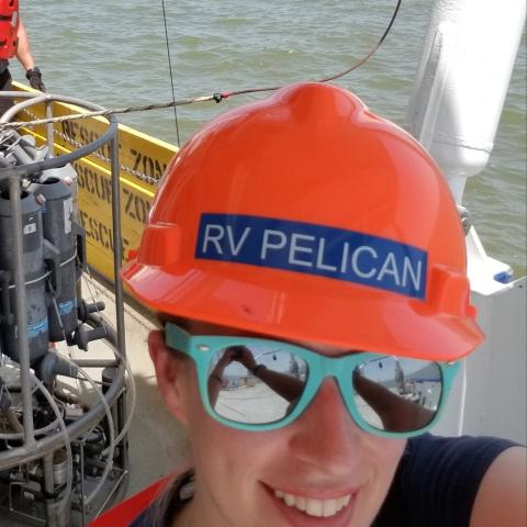 Selfie on a boat wearing sunglasses and a hard hat