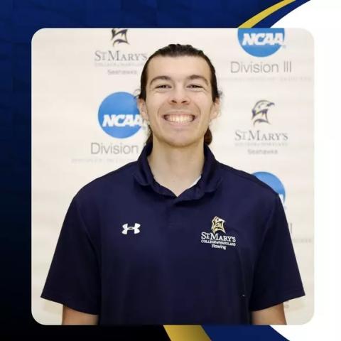 A person wearing a navy St. Mary's College Rowing shirt smiles in front of a backdrop with NCAA and St. Mary's College logos.
