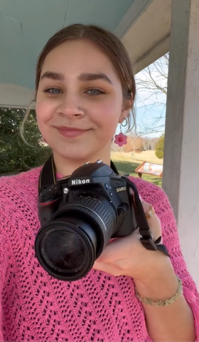 Ashlyn Conley portrait with camera in her hand 