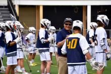 Gary Willis  talking with lacrosse team 