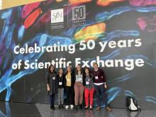Students gathered in front of Celebrating 50 years of scientific exchange banner