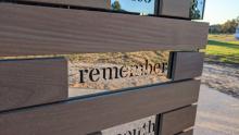 The word Remember edged in glass as part of the Commemorative