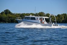 A white St. Mary’s research vessel cruising across open water.