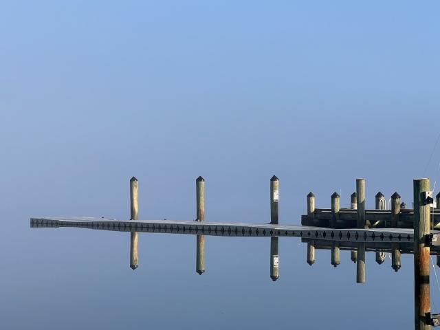 Dock and reflection in fog