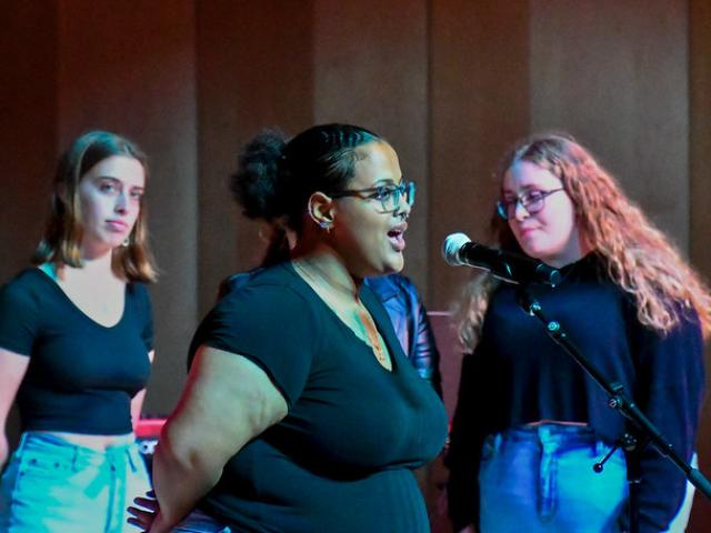 Three students singing