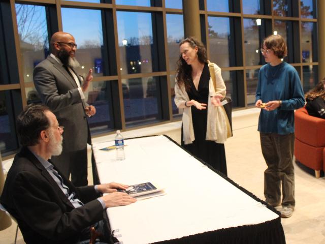 Poets John Murillo and Martin Espada are introduced by Poet Karen Leona Anderson to a student