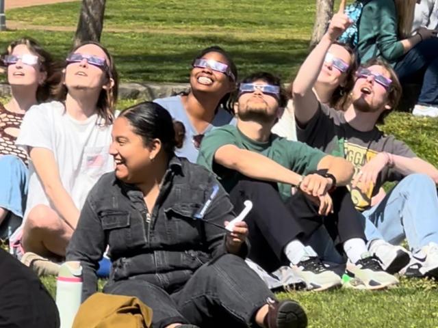 People looking up wearing eclipse glasses