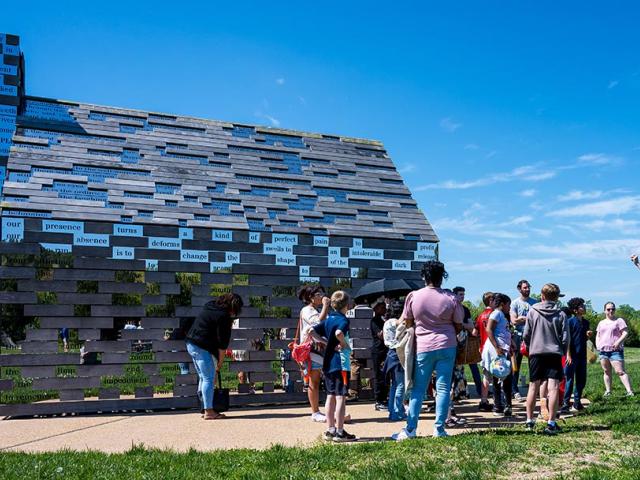 Students gathered around the Commemorative to Enslaved Peoples of Southern Maryland