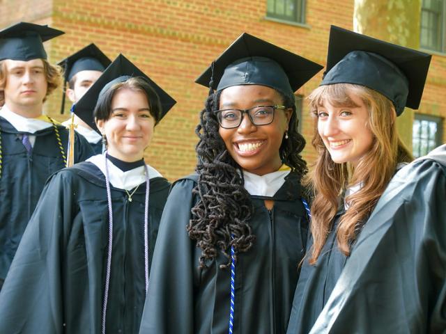 Happy graduates in cap and gown