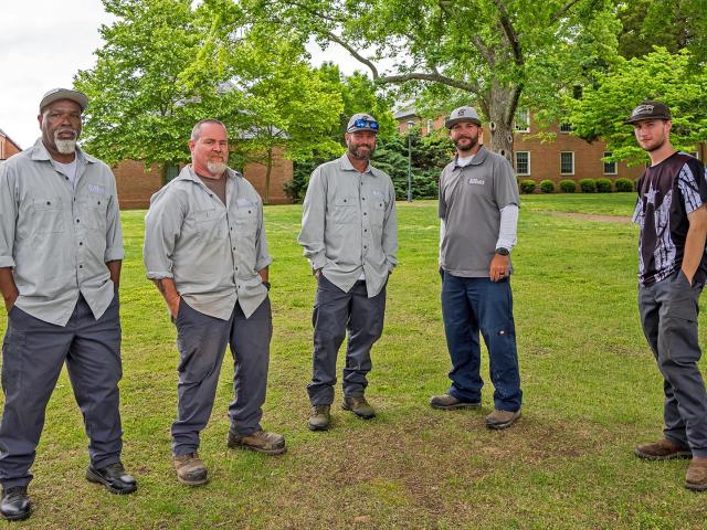 5 physical plant workers stad on the Monty pillow