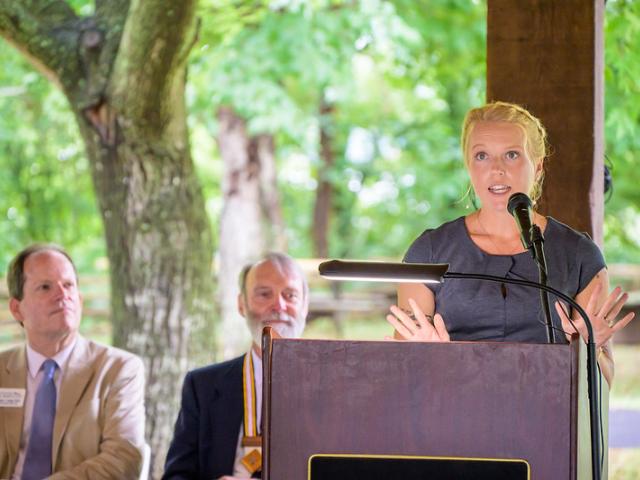 woman speaks at podium 