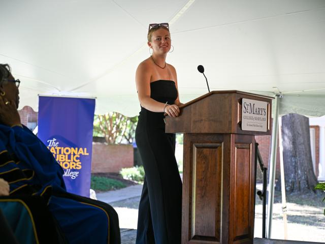 a student stands at a podium 