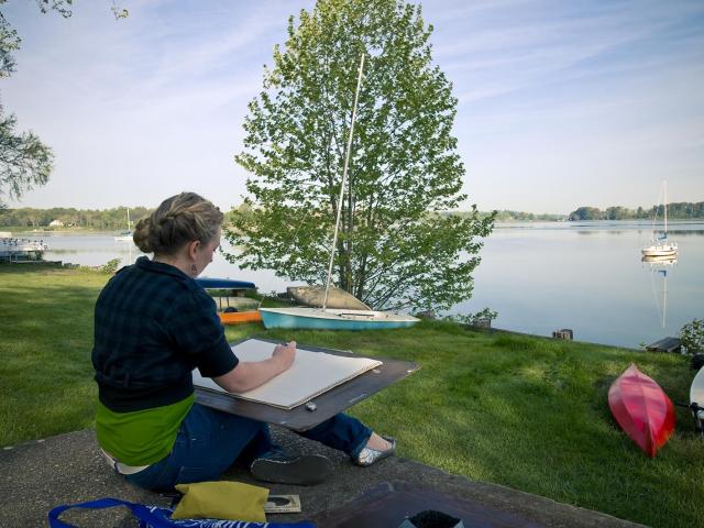 artist with canvas overlooking the St. Mary's River
