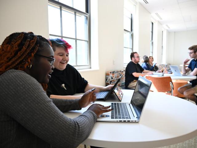Students around laptop