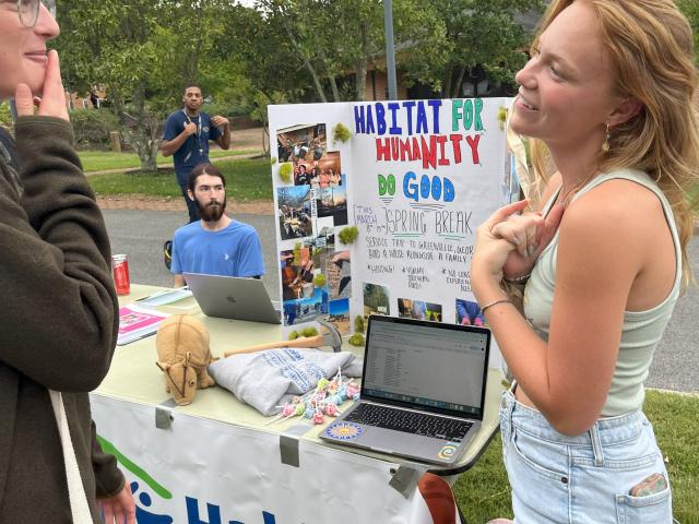 Faith Kessell (co-president) tells students about Habitat for Humanity at the Club Fair 