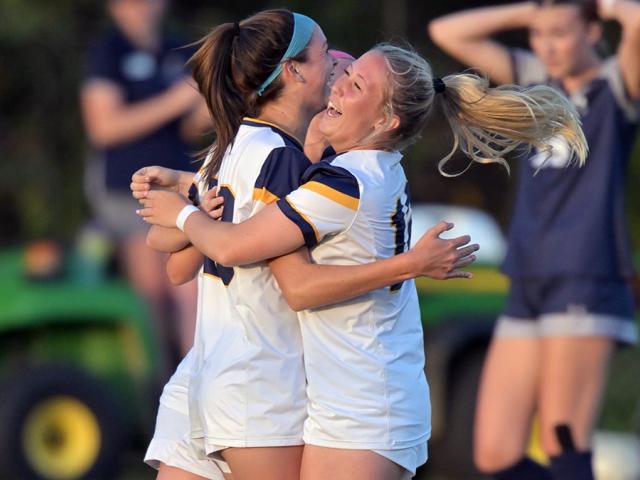 Soccer players celebrating a goal