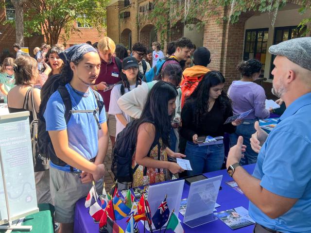 Students gather for study abroad fair on campus center patio 
