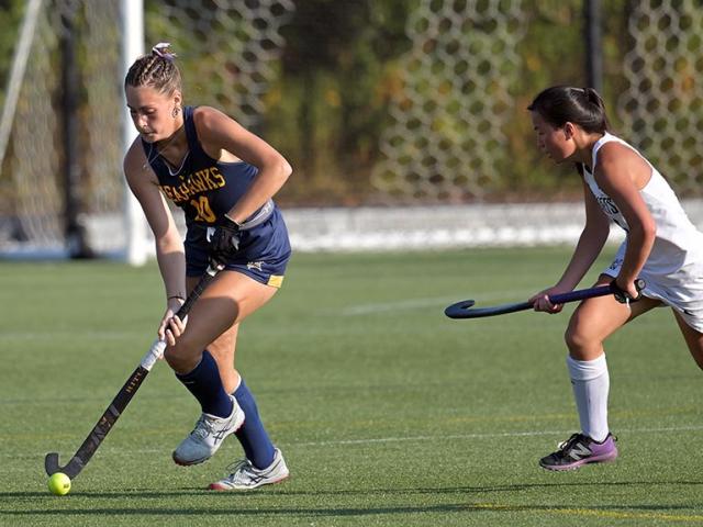 Two field hockey players in action