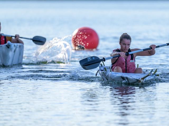 Two competitors race their bamboo boats