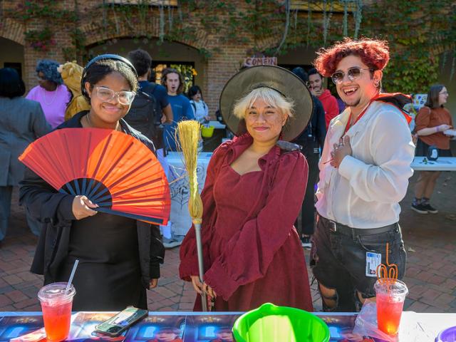 Three students in Halloween costumes