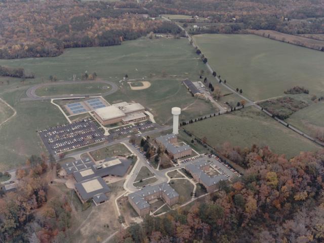 fall campus 1986 showing water tower, gym, tennis courts, track