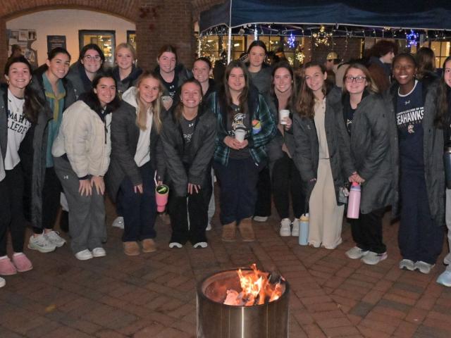 group of women at Giving Tuesday tent around fire pit