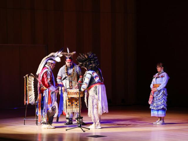 Performers on stage in Native American dress