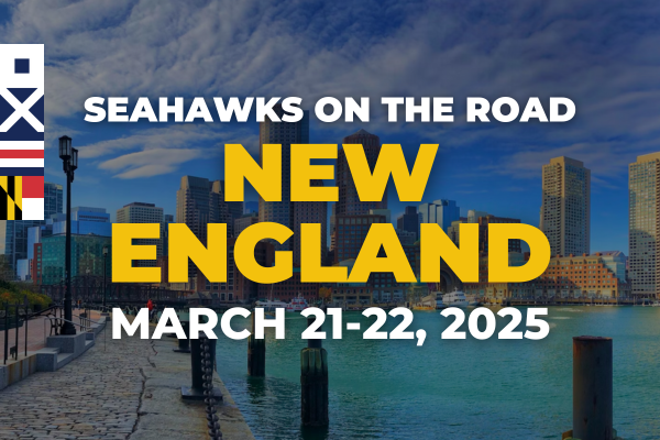 Background of a city skyline by the water under a cloudy sky. Text in the foreground reads: "Seahawks on the Road, New England, March 21-22, 2025.