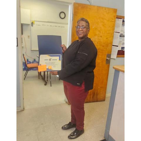 A woman holding a blue folder.