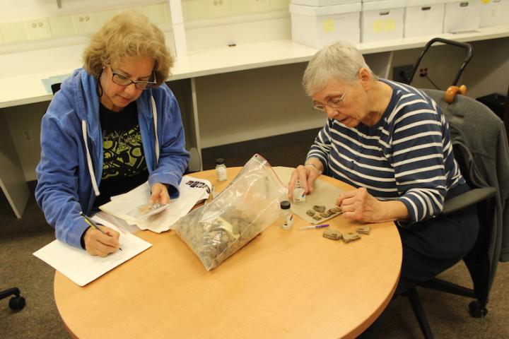 Isabel Tonkavitch and Sara Fisher cleaning and cataloging artifacts in the anthropology lab at St. Mary’s College