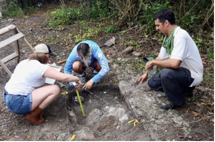St. Mary’s College students Emily Geckle and Joona Kielek record a building foundation in an excavation as Steve Lenik looks on. (Photo by Steve Lenik)