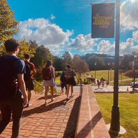 Students walking outside from Anne Arundel Hall toward Campus Center