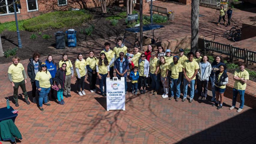 Volunteers pose on the campus patio for the kickoff of Bay to Bay service Days