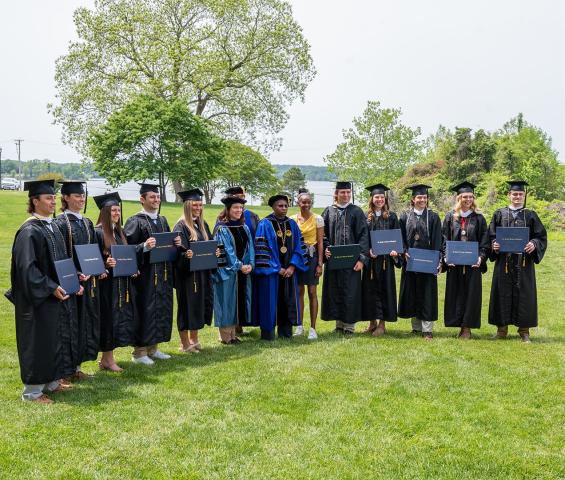 The senior members of the men’s and women’s lacrosse teams pose for grad photos after the special Grad Walk