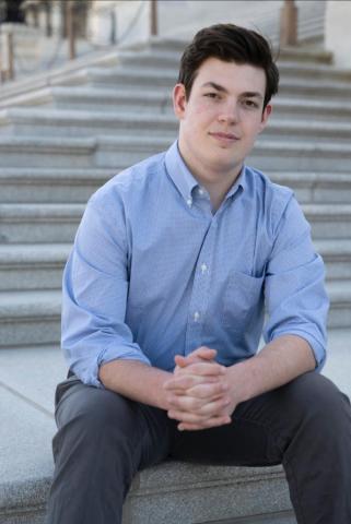 Portrait of Henry Marks sitting on steps outdoors