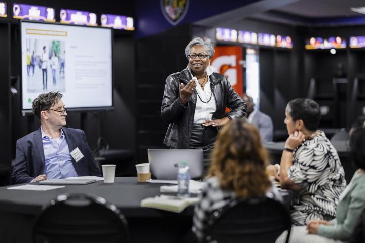 President Jordan stands before the Carnegie Post Secondary Commission at their meeting inside M&T Bank Stadium