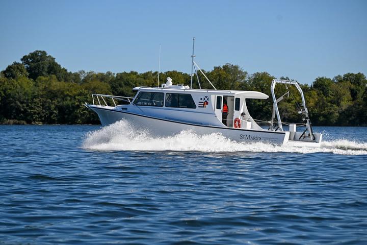 A white St. Mary’s research vessel cruising across open water.