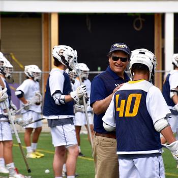 Gary Willis  talking with lacrosse team 