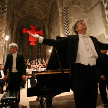 Pictured: A previous performance by Brian Ganz, left, at the Alba Music Festival in Alba, Italy, conducted by Larry Vote, center.  