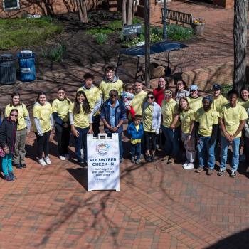 Volunteers pose on the campus patio for the kickoff of Bay to Bay service Days 